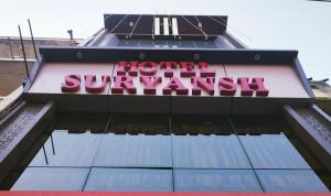 a sign on the top of a building at Hotel Suryansh in Udaipur