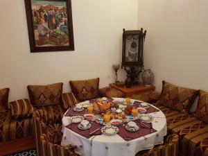 a living room with a table with a plate of food at Riad Souafine in Fez