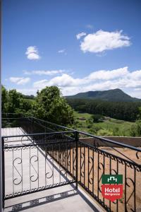 a balcony with a view of the mountains at Hotel Bergozza in Rio do Sul
