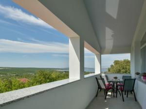 a balcony with a table and chairs and a view at Apartman Nina in Kruševo