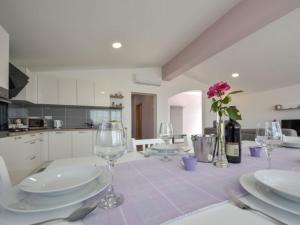 a kitchen with a table with plates and wine glasses at Apartman Nina in Kruševo