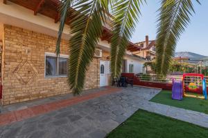 a backyard with a playground and a house at George Studios in Skala Potamias