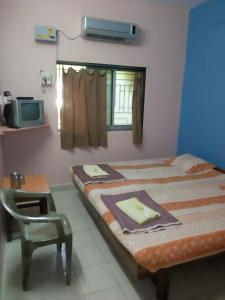 Postel nebo postele na pokoji v ubytování Hotel Anjali Lodge Malvan