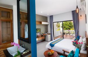 
a bedroom with a bed, a table, and a window at Krissna Villa Siem Reap in Siem Reap
