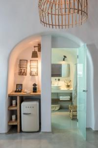 a bathroom with a sink and a counter with a sink at Cocoon Suites in Imerovigli