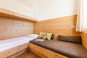 A bed or beds in a room at Family Home Alpenhof