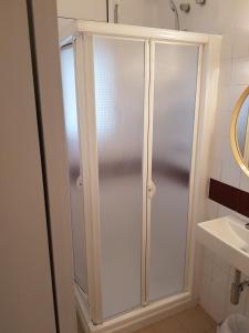 a shower stall in a bathroom with a sink at Hostal Ondina in Begur