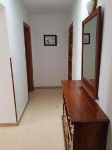 a bathroom with a mirror and a wooden dresser at Hostal Ondina in Begur