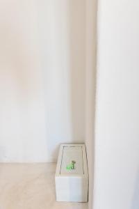 a white box sitting next to a white wall at Memento Perissa in Perissa
