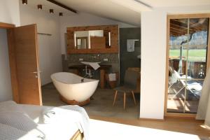 a bathroom with a bath tub in a room at Appartements "Da Zillertaler und die Geigerin" in Mayrhofen +54 photos
