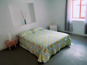 a bedroom with a bed with a yellow bedspread and a window at Casa I Love Huaraz in Huaraz +13 photos