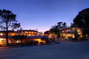 a large building with a lot of windows and trees at Horizon Inn & Ocean View Lodge in Carmel