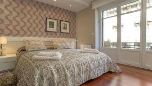 a bedroom with a bed with two pillows on it at Downtown Design Apartment in Donostia-San Sebastián