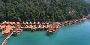 a row of umbrellas and chairs in the water at Berjaya Langkawi Resort in Pantai Kok