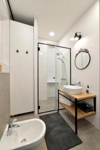 a bathroom with a sink and a toilet and a shower at Fishnjak Apartments - Central Zagreb in Zagreb