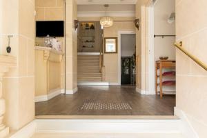 a hallway of a home with a staircase and a hallway at Brit Hôtel Confort Cléria Lorient Centre in Lorient