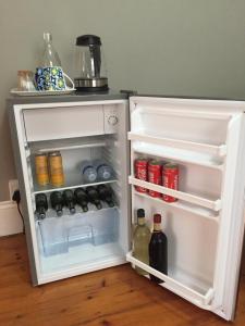 an open refrigerator filled with lots of drinks and bottles at Casa Mia in Pietermaritzburg