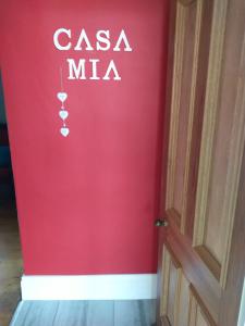 a red door with the words casa mica on it at Casa Mia in Pietermaritzburg