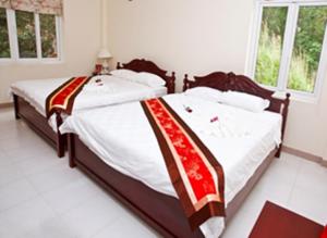 Postel nebo postele na pokoji v ubytování Nathalie's Vung Tau Hotel