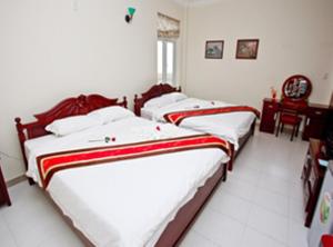Postel nebo postele na pokoji v ubytování Nathalie's Vung Tau Hotel