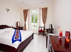 Postel nebo postele na pokoji v ubytování Nathalie's Vung Tau Hotel