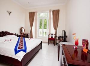Postel nebo postele na pokoji v ubytování Nathalie's Vung Tau Hotel