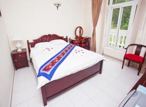 Postel nebo postele na pokoji v ubytování Nathalie's Vung Tau Hotel