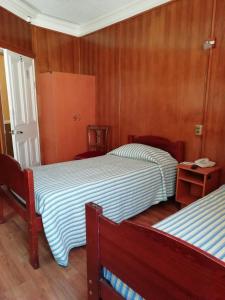 Postel nebo postele na pokoji v ubytování Hostal Dinamarca