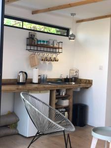 a kitchen with a counter and a chair in a room at A secret Oasis in Eilat