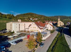 an aerial view of a town with cars parked in a parking lot at Landhotel Wilder Mann in Eggingen