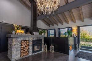 a fireplace in a living room with a chandelier at Fonda Matía in Bellver de Cerdanya