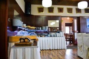 a kitchen with two tables with white table cloth at Hotel Krakonos in Rokytnice nad Jizerou