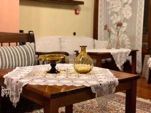 a table with a glass vase on top of it at Varosi Guesthouse in Edessa