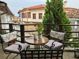 a table and chairs on a balcony with a view at Varosi Guesthouse in Edessa