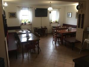 a dining room with tables and chairs in a restaurant at Penzion Lipno Jantar in Horní Planá