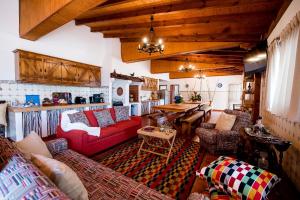 a living room with red couches and a table at Vale do Grou Natura in Óbidos