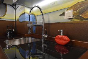 a kitchen with a sink and two faucets at Dali Aparthotel in Koszalin