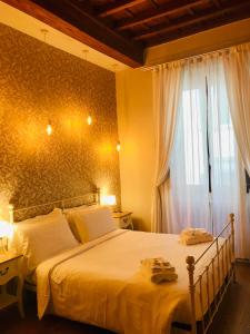 a bedroom with a large bed and a window at Assaporarte in Florence