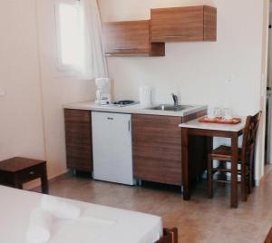a small kitchen with a sink and a table at Studios Nikolaou Bros in Parga +35 photos