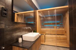 a bathroom with a sink and a shower at Stylish Loft with Finnish SAUNA in Budapest
