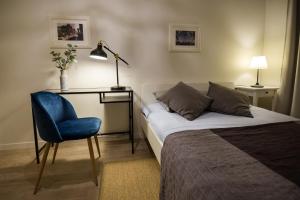 una camera con letto, scrivania e sedia blu di Renovated apartment in Riga center a Riga