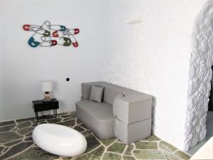 a living room with a couch and a chair at AMO Folegandros in Karavostasi