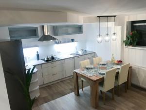 a kitchen with a table and chairs in a kitchen at Apartment Tosca near Vintgar and Lake Bled in Zgornje Gorje