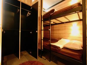 a bunk bed room with two bunk beds in it at Namba Guesthouse HIVE in Osaka