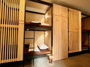 a room with two bunk beds in it at Namba Guesthouse HIVE in Osaka