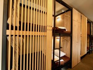 a room with a closet with wooden walls at Namba Guesthouse HIVE in Osaka