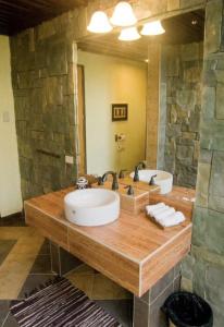 a bathroom with two sinks and a large mirror at M Villa’s Farm Resort in Romblon