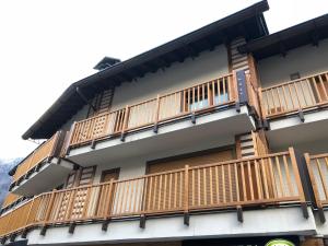 a building with wooden balconies on the side of it at PETITE MAISON a 50 passi dalla funivia !!! in Courmayeur