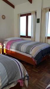Letto o letti in una camera di Hostal Inti Wayra