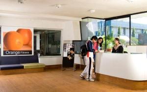 a group of people standing at a counter in a building at LCH Fitness in Indore